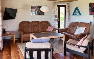 a living room with a couch and a table at Stunning Home In Hundested With Wifi in Hundested