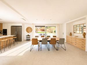 a kitchen and dining room with a table and chairs at Naramia Sagaro Villa - with Pool-garden-10 Pax in S'agaro
