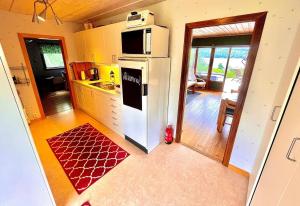 a kitchen with a white refrigerator in a room at Hemsö Hideaway in Kojbacken