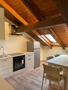 a kitchen with a table and a stove top oven at Seandre Holiday Apartments in Prada