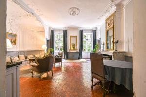 a large living room with a table and chairs at Château De Jouques in Gémenos