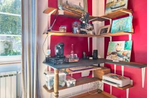 a room with pink walls and wooden shelves at Chambres en Charente Maritime in Loiré-sur-Nie