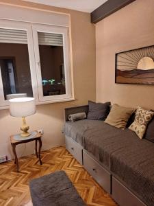 a bedroom with a large bed with a window at Golubac Bay Apartment in Golubac