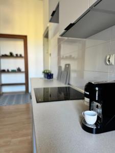 a kitchen with a toaster and a coffee maker on a counter at Apartament przy Kościele in Świdnica