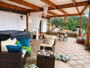 a patio with a couch and chairs and a table at A Encantada Spa e Vista 180 Casa de Artista in Alqueve