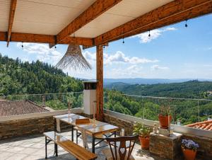 a patio with a table and chairs and a view at A Encantada Spa e Vista 180 Casa de Artista in Alqueve