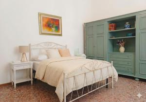 a bedroom with a bed with a green cabinet at Simohouse Lecce - Executive Suite Apartment 140mq - 2 Bathrooms in Lecce