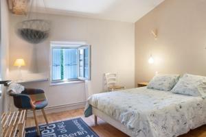 a bedroom with a bed and a chair and a window at Chambres en Charente Maritime in Loiré-sur-Nie +28 photos