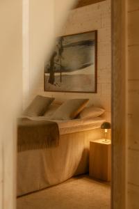 a bedroom with two beds and a painting on the wall at Ainur Villas in Saariselka