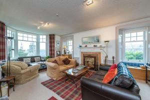 a living room filled with furniture and a fireplace at Arduthie House in Stonehaven