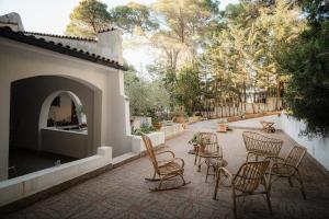 a group of chairs and tables on a patio at Villa Elefante in Isole Tremiti