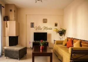 a living room with a couch and a table at Villa Maria in Ierissos