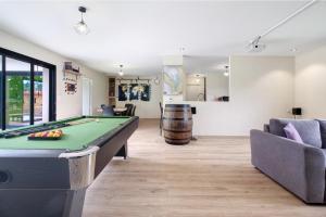 a living room with a pool table and a couch at Maison Peyrelade in Coulounieix-Chamiers