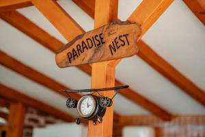 a wooden arrow sign with a clock and a pharmacyacistacistacistacistacistacist at Paradise Nest in Ohrid