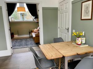 a dining room with a wooden table and chairs at The Old Schoolhouse, Kinross in Kinross