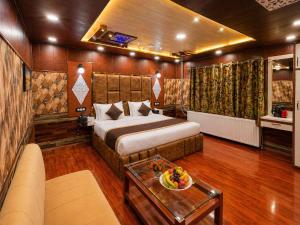 a hotel room with a bed and a table at Pine View Resort in Gulmarg