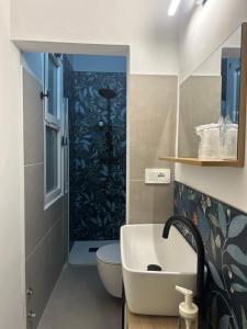 a bathroom with a sink and a toilet and a shower at Hotel Sylva in Cattolica