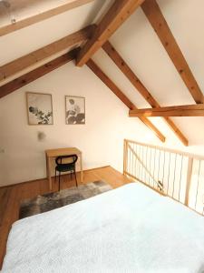 a bedroom with a bed and a desk at Südsteirer Suite in Bad Radkersburg