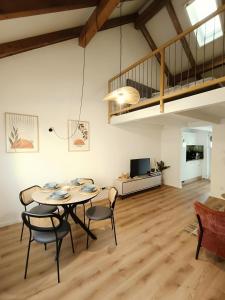 a living room with a table and chairs and a couch at Südsteirer Suite in Bad Radkersburg