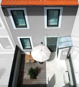 an overhead view of a building with an umbrella at Allegro Patio House in Porto