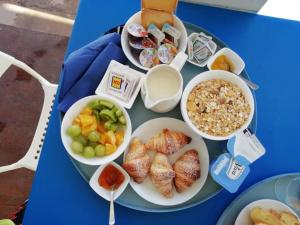 a blue table topped with a tray of food at BorgoMarino's Room in Cefalù