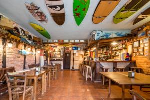 a restaurant with tables and surfboards on the wall at Casa Del Surf Somo in Somo +91 photos