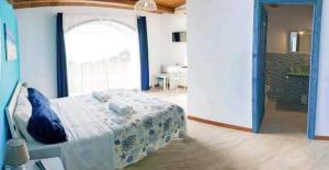 a bedroom with a bed and a large window at BorgoMarino's Room in Cefalù +4 photos
