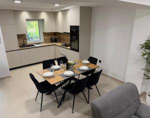 a kitchen and dining room with a table and chairs at Holiday Home Nada in Tučepi