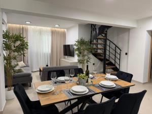 a dining room with a table and chairs and a staircase at Holiday Home Nada in Tučepi +25 photos