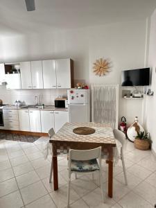 a kitchen with a table and chairs in a room at White House in Torre Canne +26 photos