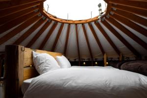 a bedroom with a bed in a yurt at The Yurts at Margo's Garden, Kiroro in Shiribeshi
