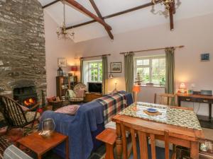 a living room with a couch and a fireplace at Tyn Y Fron in Llanrhystyd