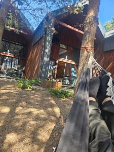 a person laying in a hammock in front of a house at Michal in Tleń