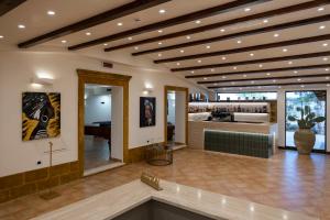 a large lobby with a large room with a fireplace at Villa Demetra Resort in San Leone +66 photos