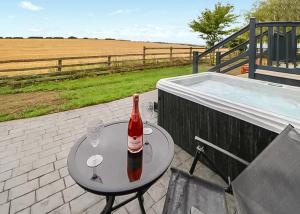 a bottle of wine sitting on a table next to a hot tub at Hillcrest Hideaways in Caldwell