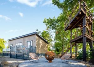 a tiny house with a gazebo and chairs at Hillcrest Hideaways in Caldwell