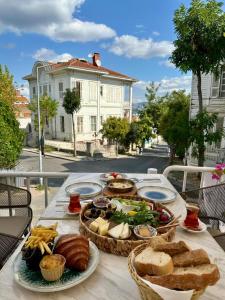 a table with bread and baskets of food on it at Palm Villa Büyükada in Istanbul