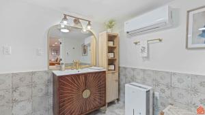 a bathroom with a sink and a mirror at Swiftie Suite Beach Getaway Studio in Santa Rosa Beach