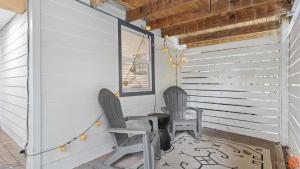 two chairs sitting on the porch of a house at Swiftie Suite Beach Getaway Studio in Santa Rosa Beach