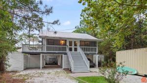 a house with a staircase leading up to it at Swiftie Suite Beach Getaway Studio in Santa Rosa Beach