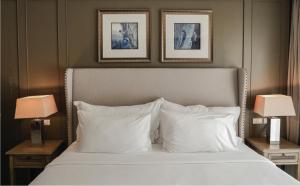 a bedroom with a bed with two lamps and two pictures at Sugar Marina Hotel CLIFFHANGER Aonang in Ao Nang Beach