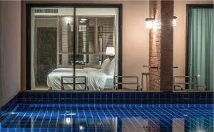 a swimming pool in a room with a bedroom at Sugar Marina Hotel CLIFFHANGER Aonang in Ao Nang Beach
