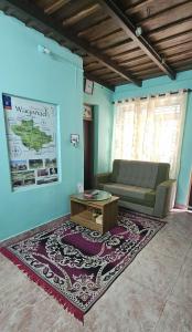 a living room with a couch and a coffee table at Johny's Villa, Homestay, Wayanad in Pulpally