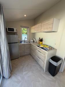 a small kitchen with a sink and a refrigerator at Bahia in Le Faulq +3 photos