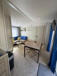 a living room with a table and a couch at Bahia in Le Faulq