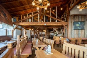 a dining room with wooden tables and chairs at Bayerische Gastwirtschaft Dimpfl-Stadl in Lam