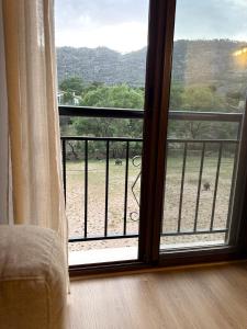 a room with a window with a view of a field at Duplex El Acebuche in Arroyo Frio
