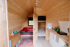a small bedroom with a bed in a wooden cabin at Reservoir View Micro Cabin in Dol-y-gaer Station +12 photos