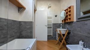 a bathroom with a tub and a sink and a mirror at La Corte Di Dafne in Bergamo +30 photos