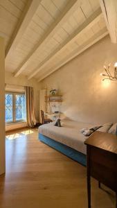 a bedroom with a bed and a large window at La Corte Di Dafne in Bergamo